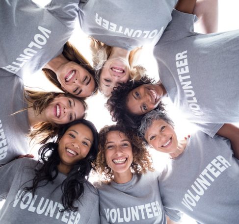 Happy multi-ethnic volunteers forming a huddle 703860